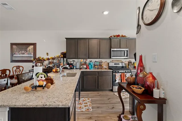 a view of a kitchen with granite countertop a table and chairs