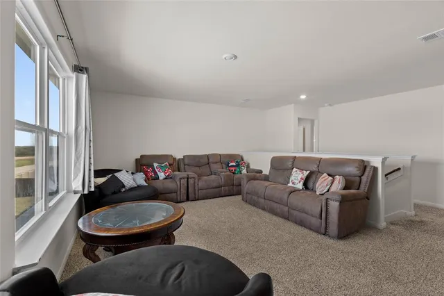 a bedroom with a bed a dresser and book shelf