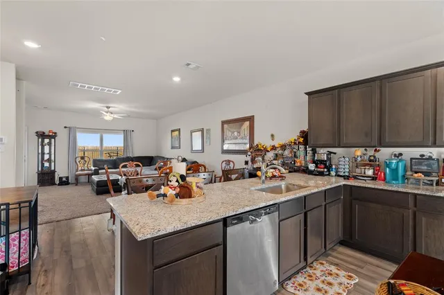 a view of house with backyard and seating area