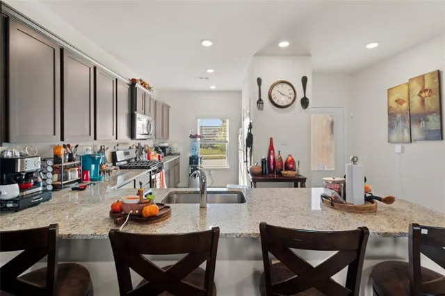 a very nice looking dining room with a large dining table and chairs