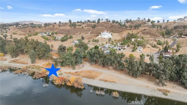 an aerial view of a town with big trees
