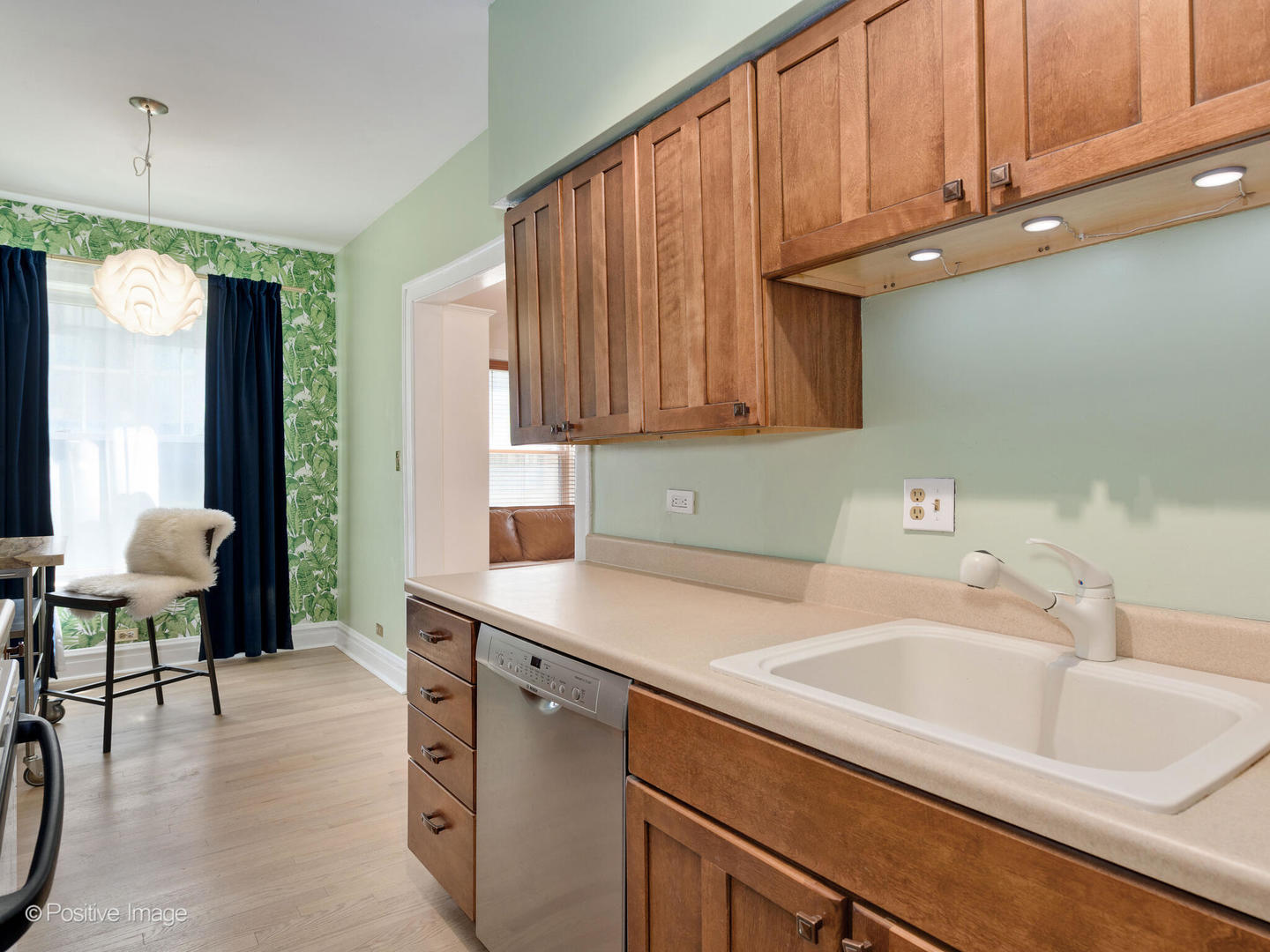 6259 North Sheridan Road, Unit 50 Chicago, IL 60660 - Photo 11 of 18 a kitchen with a sink cabinets and a window
