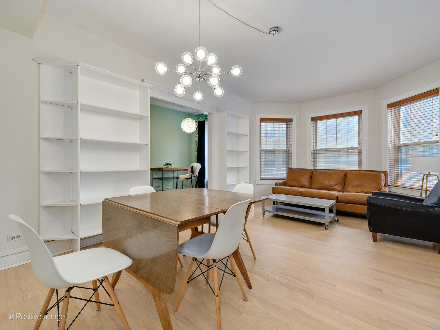 6259 North Sheridan Road, Unit 50 Chicago, IL 60660 - Photo 2 of 18 a living room with furniture a chandelier a rug and a window