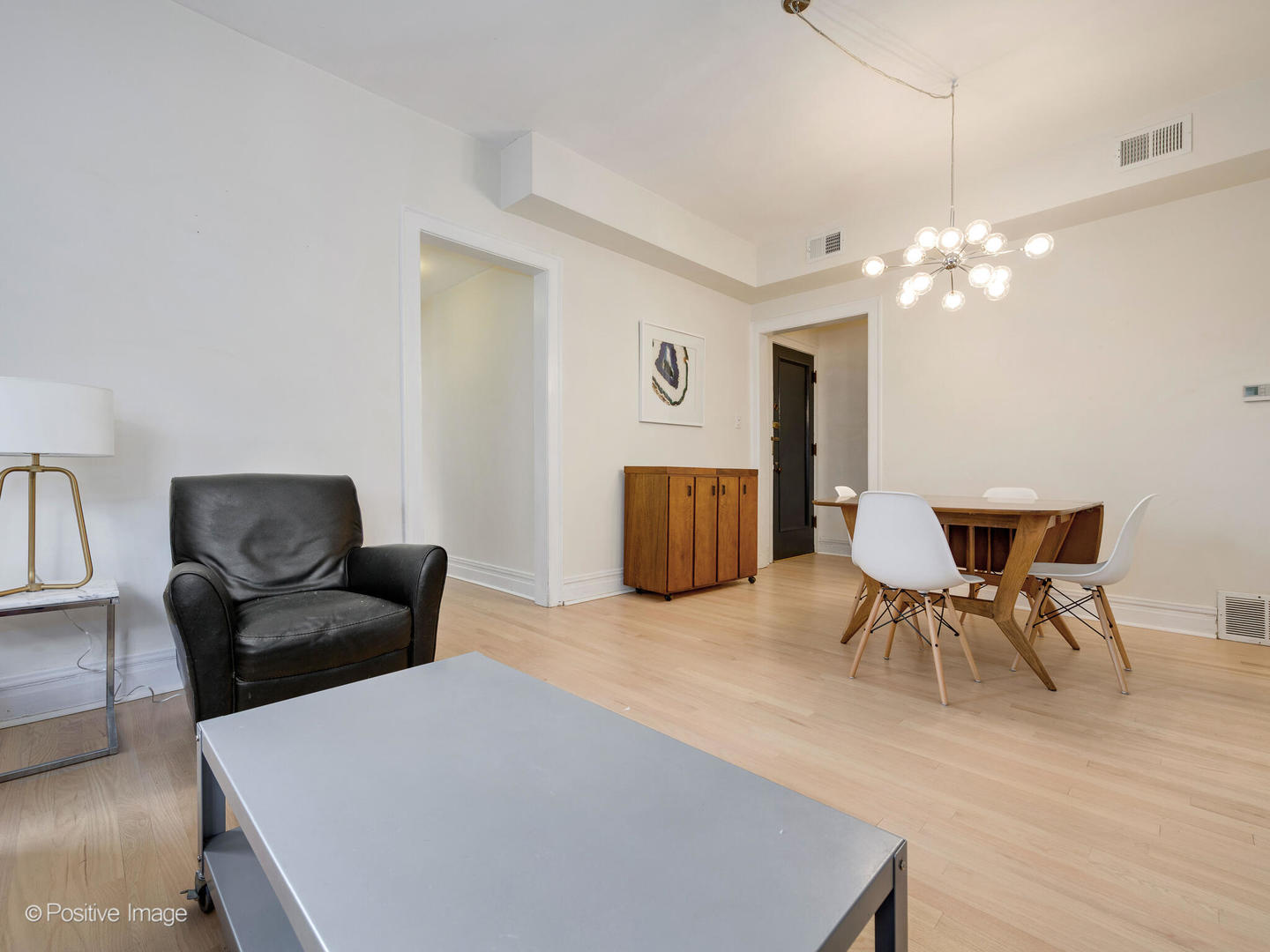 6259 North Sheridan Road, Unit 50 Chicago, IL 60660 - Photo 4 of 18 a living room with furniture and a chandelier
