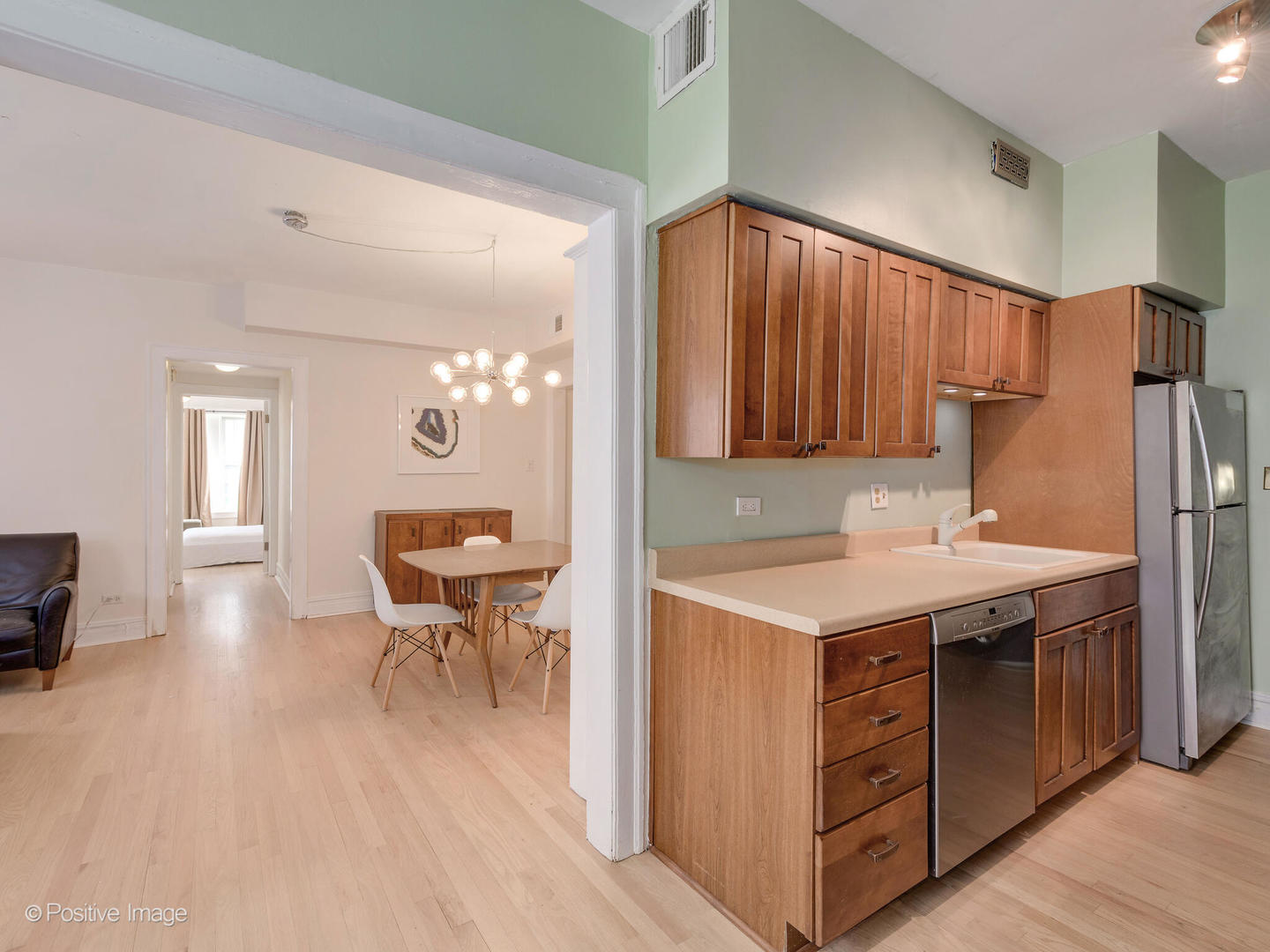 6259 North Sheridan Road, Unit 50 Chicago, IL 60660 - Photo 10 of 18 a kitchen with a sink a stove a refrigerator and chairs