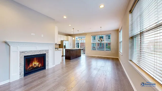 a view of an empty room with a fireplace and a window