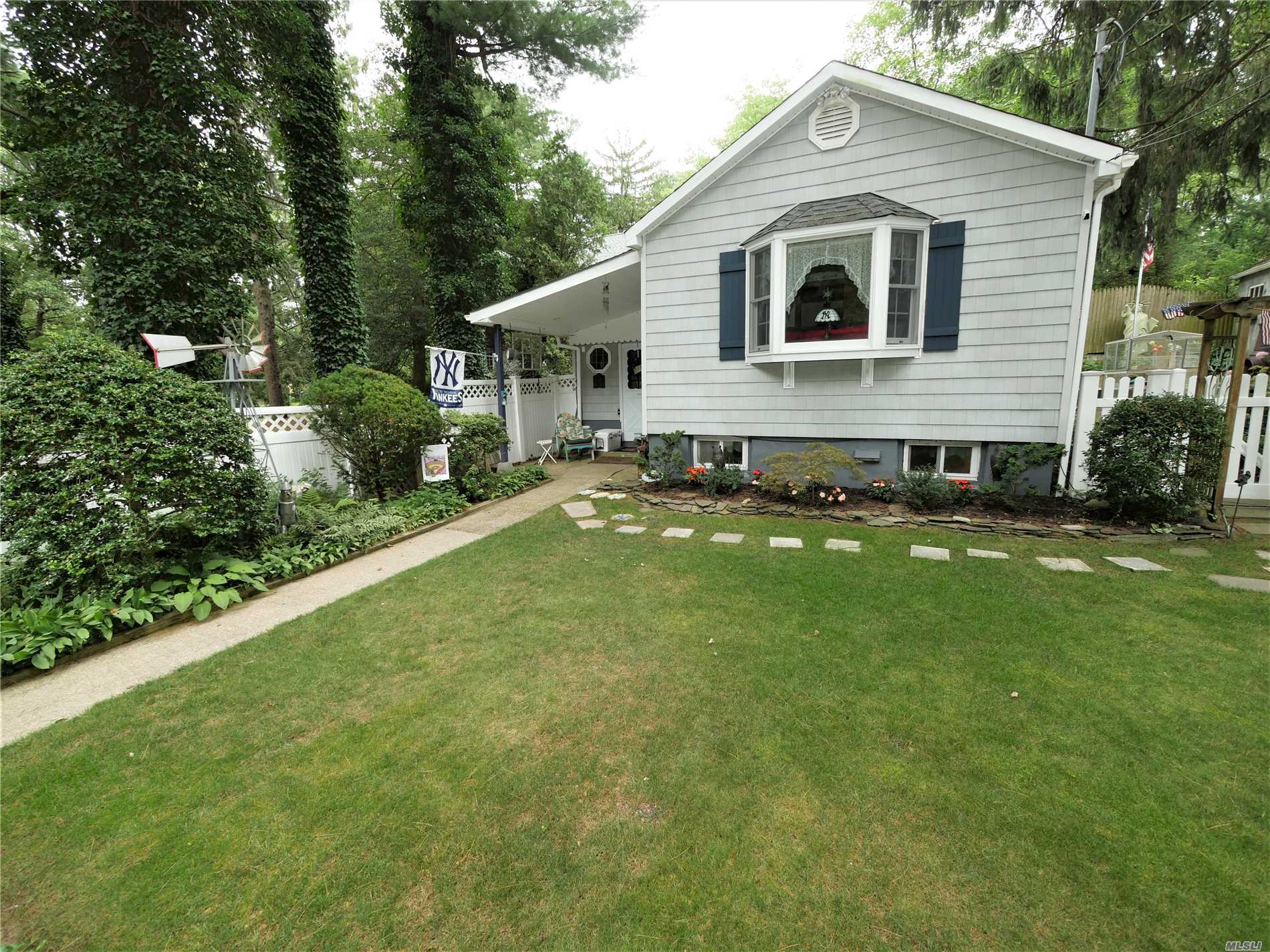 4 Whitestone Road Sound Beach, NY 11789 - Photo 1 of 1 a front view of a house with a yard