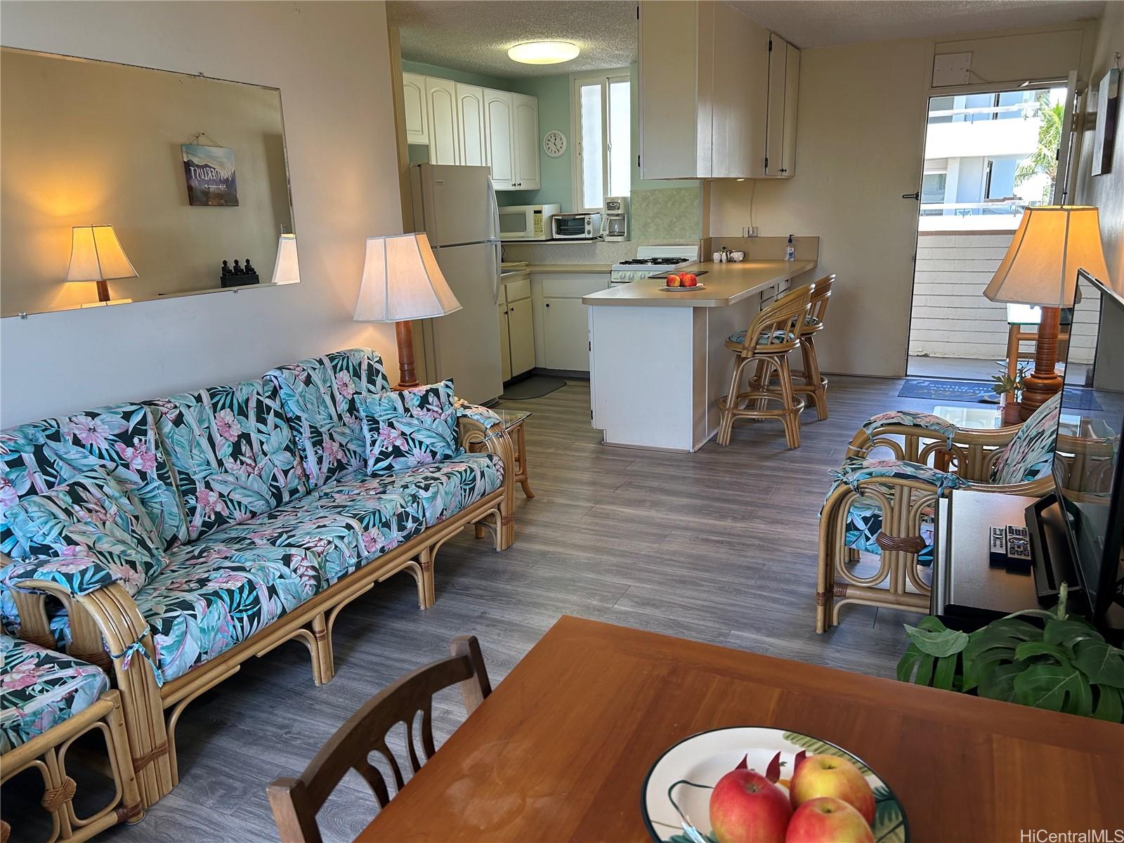 454 Nāmāhana Street, Unit 701 Honolulu, HI 96815 - Photo 11 of 25 a bedroom with furniture and a wooden floor