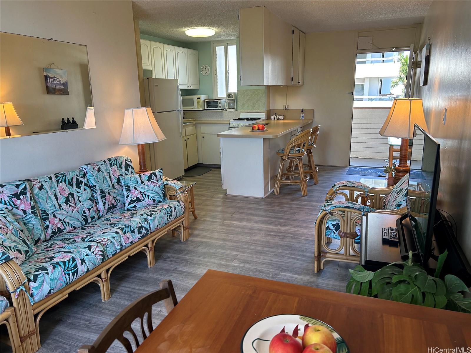 454 Nāmāhana Street, Unit 701 Honolulu, HI 96815 - Photo 12 of 25 a kitchen with kitchen island stainless steel appliances stove a dining table and chairs