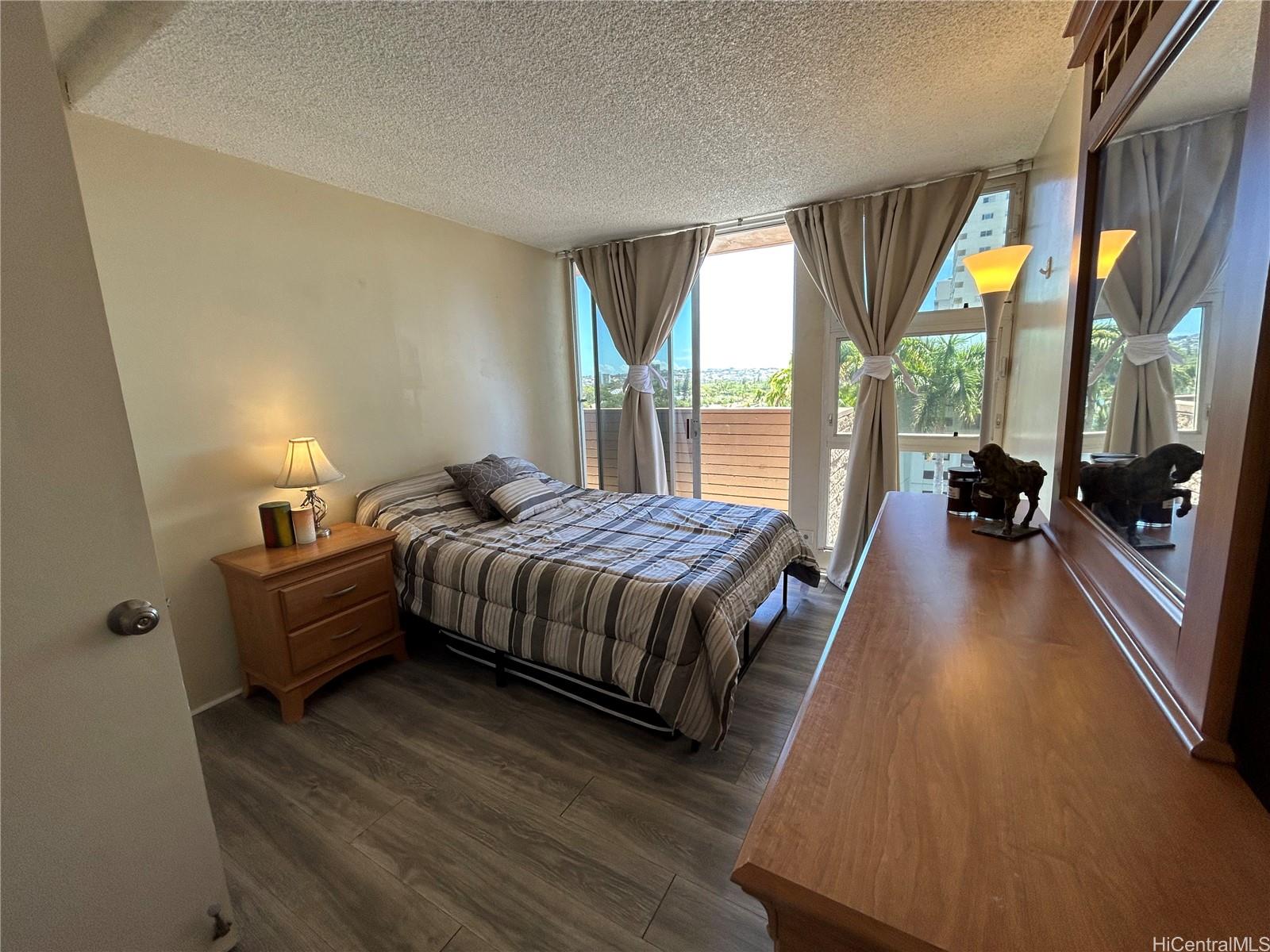 454 Nāmāhana Street, Unit 701 Honolulu, HI 96815 - Photo 18 of 25 a spacious bedroom with a bed and a large window