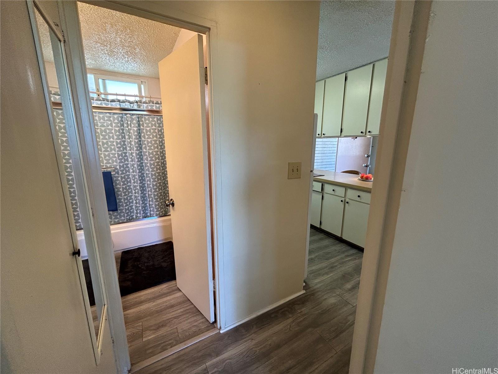 454 Nāmāhana Street, Unit 701 Honolulu, HI 96815 - Photo 20 of 25 a view of a hallway with wooden floor and closet