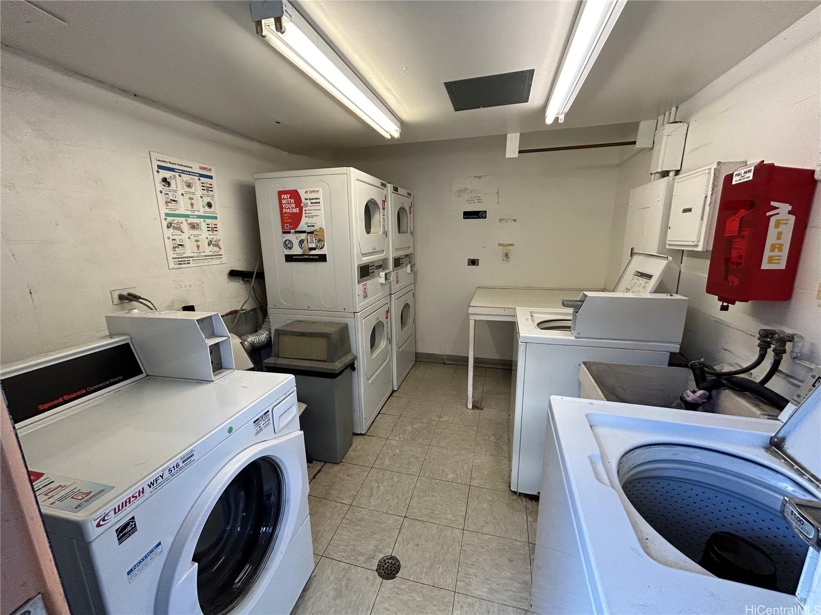 454 Nāmāhana Street, Unit 701 Honolulu, HI 96815 - Photo 25 of 25 a utility room with dryer washer and a view of living room