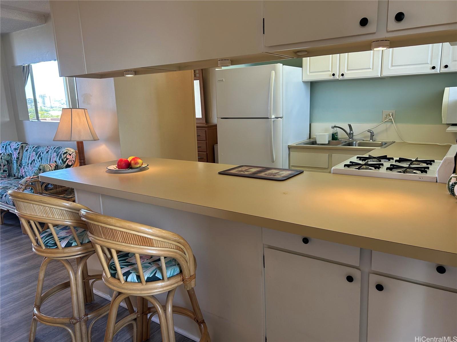 454 Nāmāhana Street, Unit 701 Honolulu, HI 96815 - Photo 5 of 25 a dining room with stainless steel appliances furniture a window and chairs