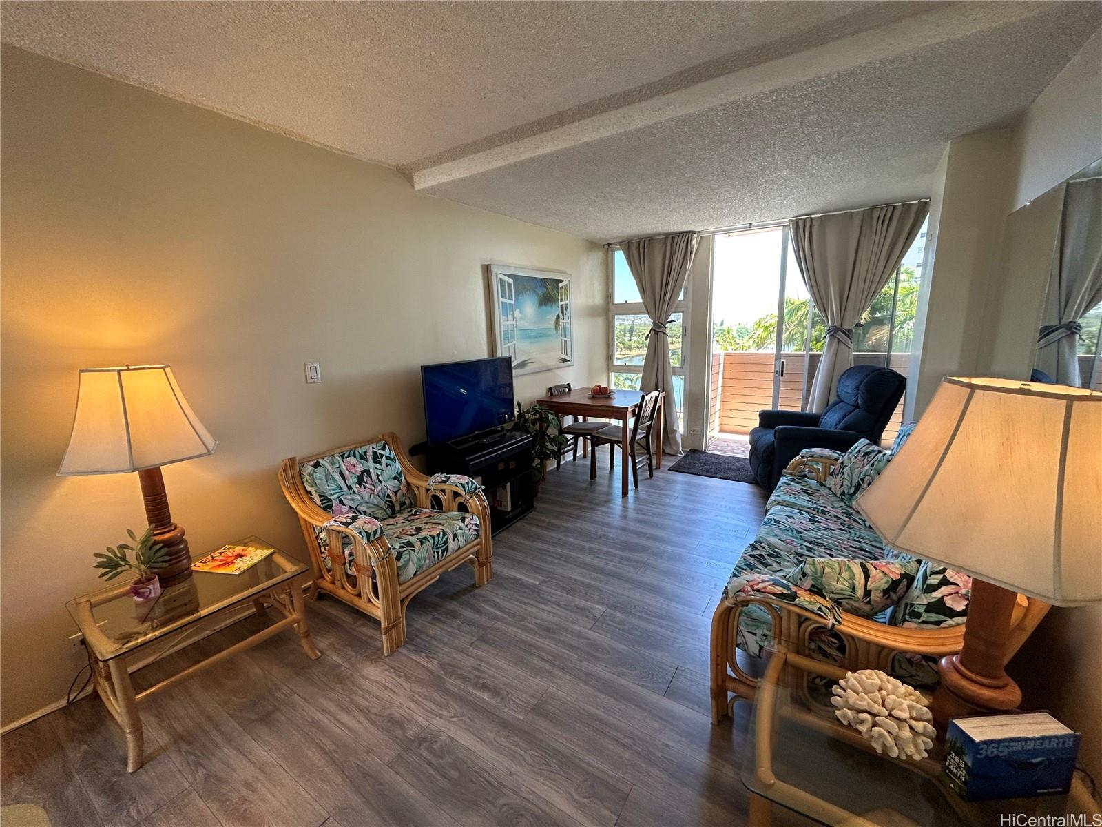 454 Nāmāhana Street, Unit 701 Honolulu, HI 96815 - Photo 8 of 25 a living room with furniture and wooden floor