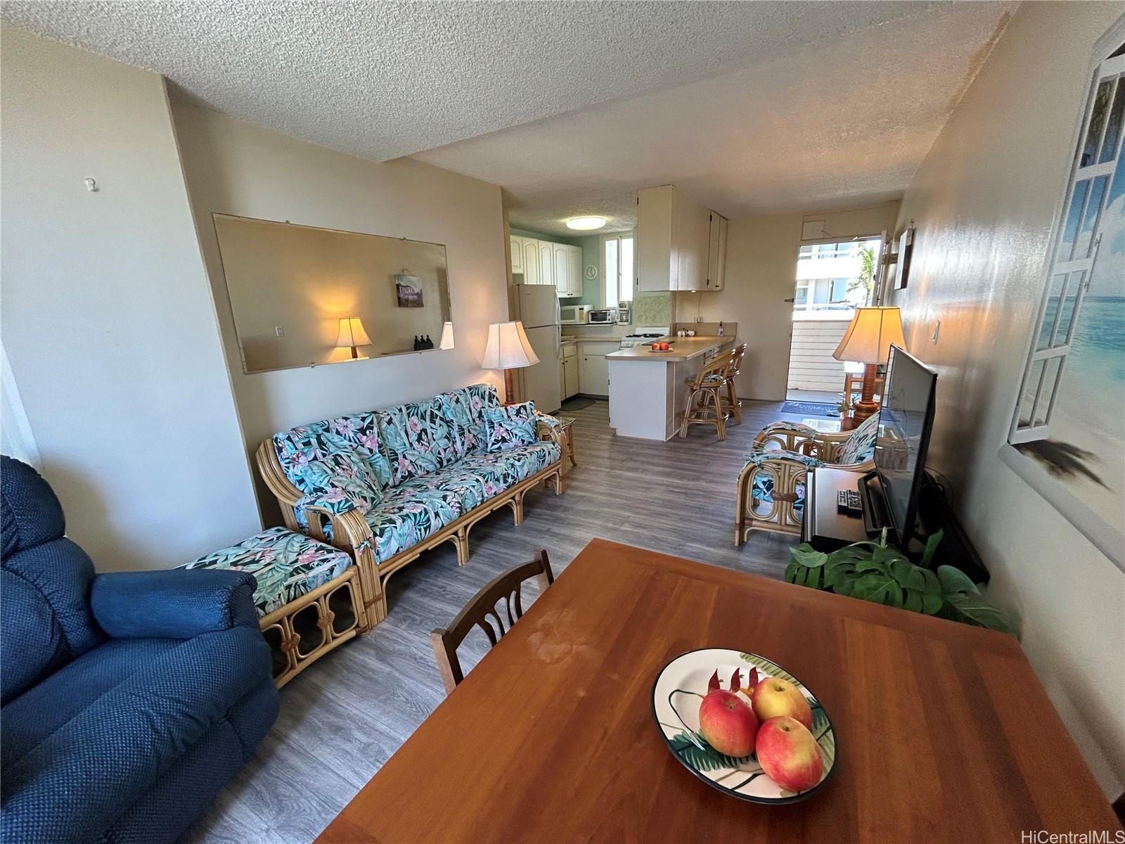 454 Nāmāhana Street, Unit 701 Honolulu, HI 96815 - Photo 9 of 25 a living room with a couch and a table