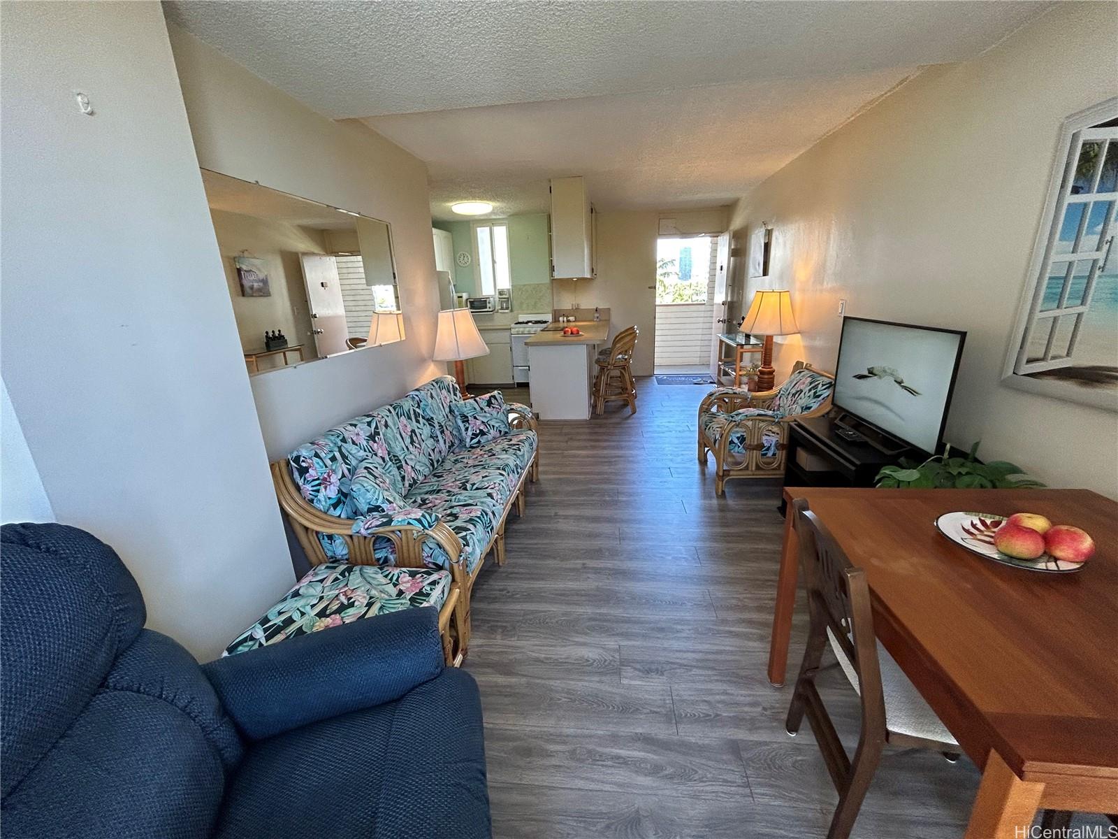 454 Nāmāhana Street, Unit 701 Honolulu, HI 96815 - Photo 10 of 25 a living room with furniture and a table