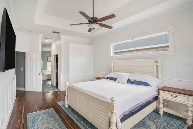 a bedroom with a bed and a ceiling fan