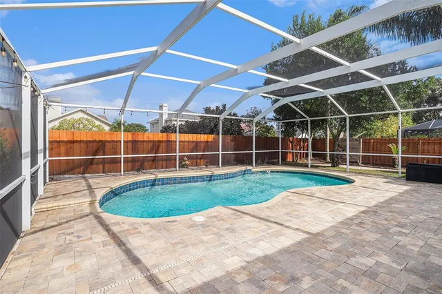 a view of a backyard with wooden floor and fence