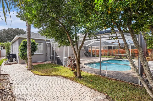 a view of a house with backyard and sitting area