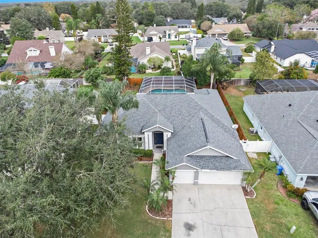 an aerial view of multiple houses with yard