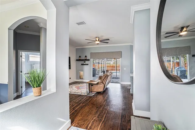 a living room with furniture and a mirror