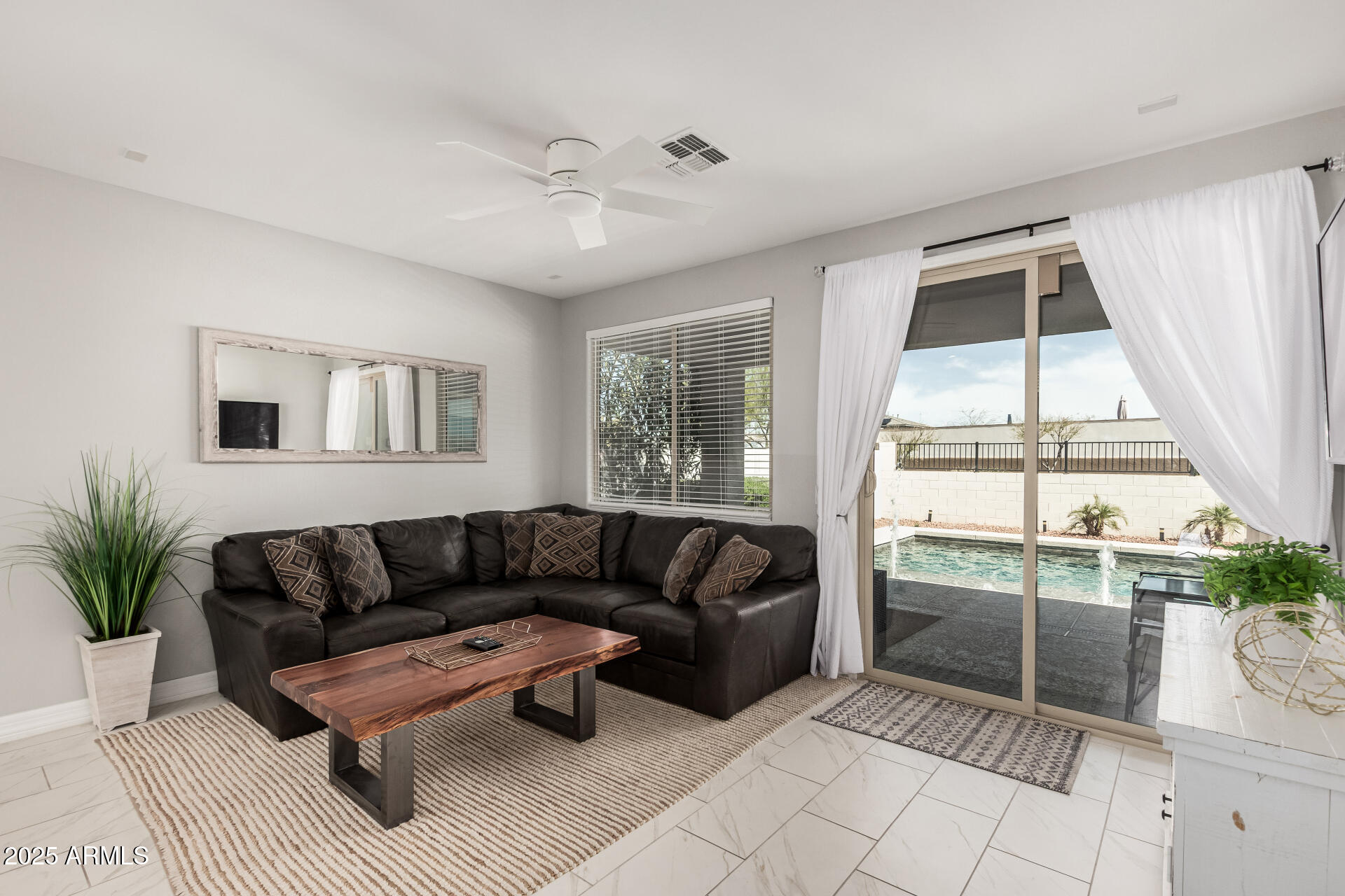 17784 West Sandy Road Goodyear, AZ 85338 - Photo 12 of 38 a living room with furniture and a large window