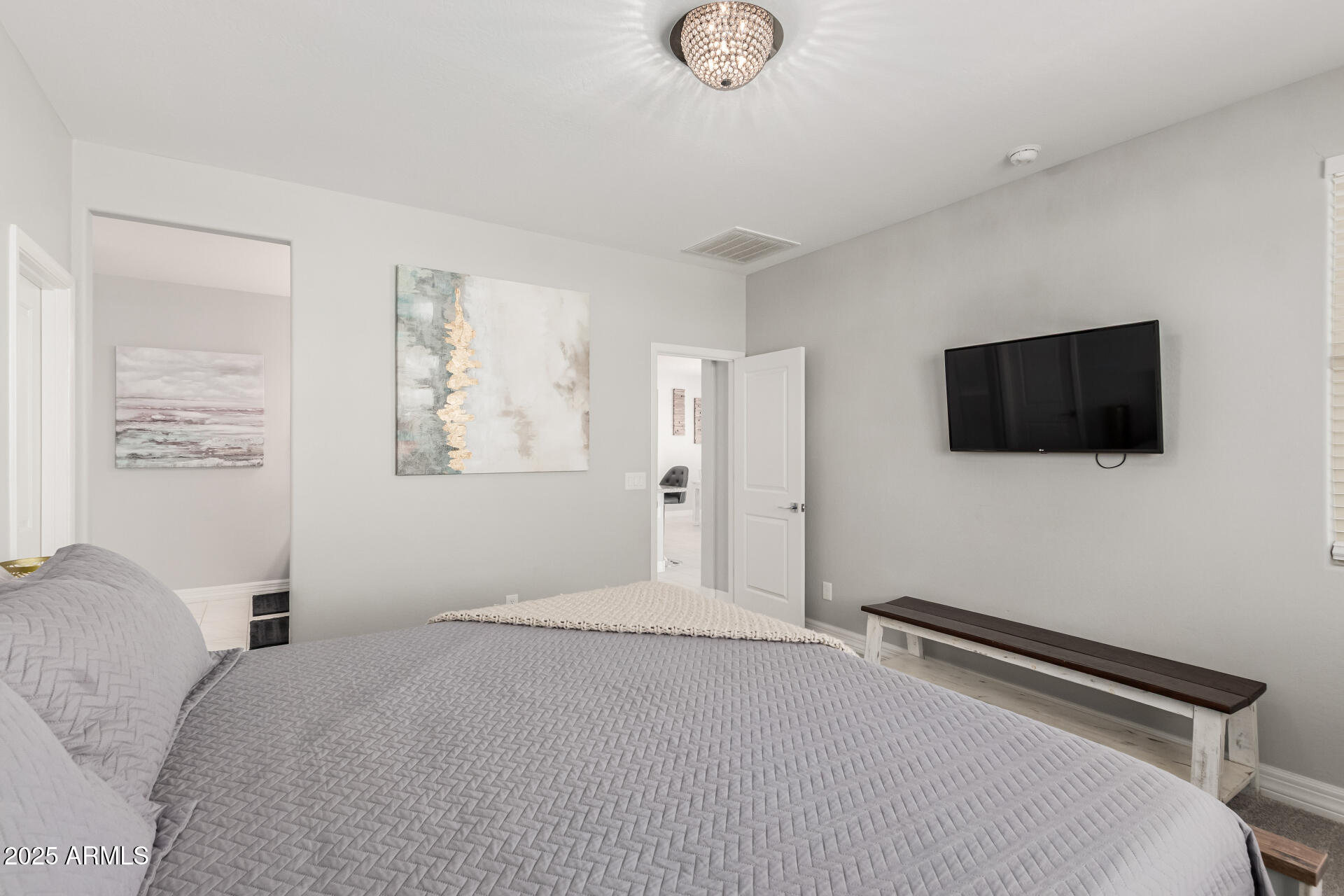 17784 West Sandy Road Goodyear, AZ 85338 - Photo 18 of 38 a bedroom with a bed and a flat screen tv