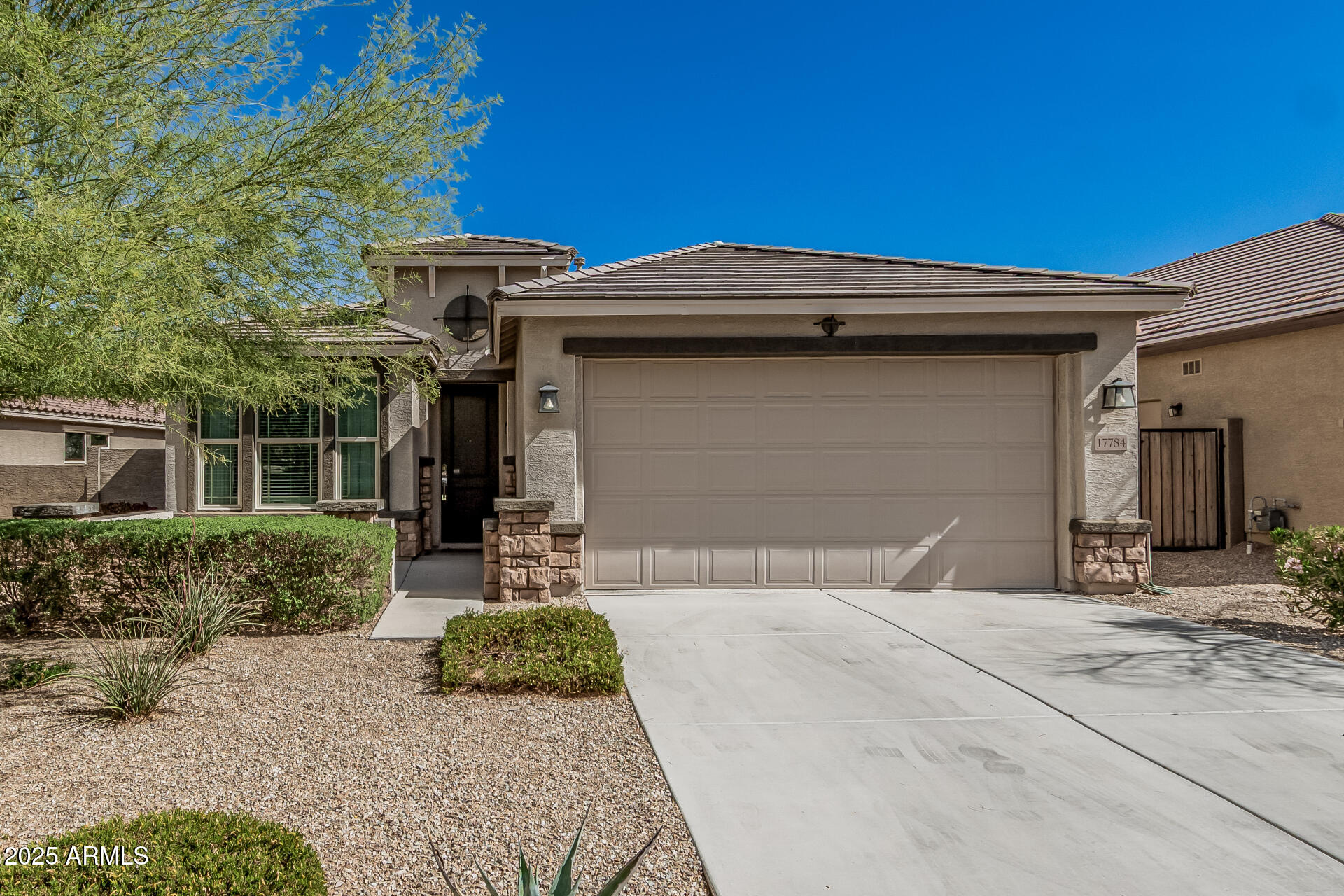 17784 West Sandy Road Goodyear, AZ 85338 - Photo 2 of 38 a front view of a house with garden
