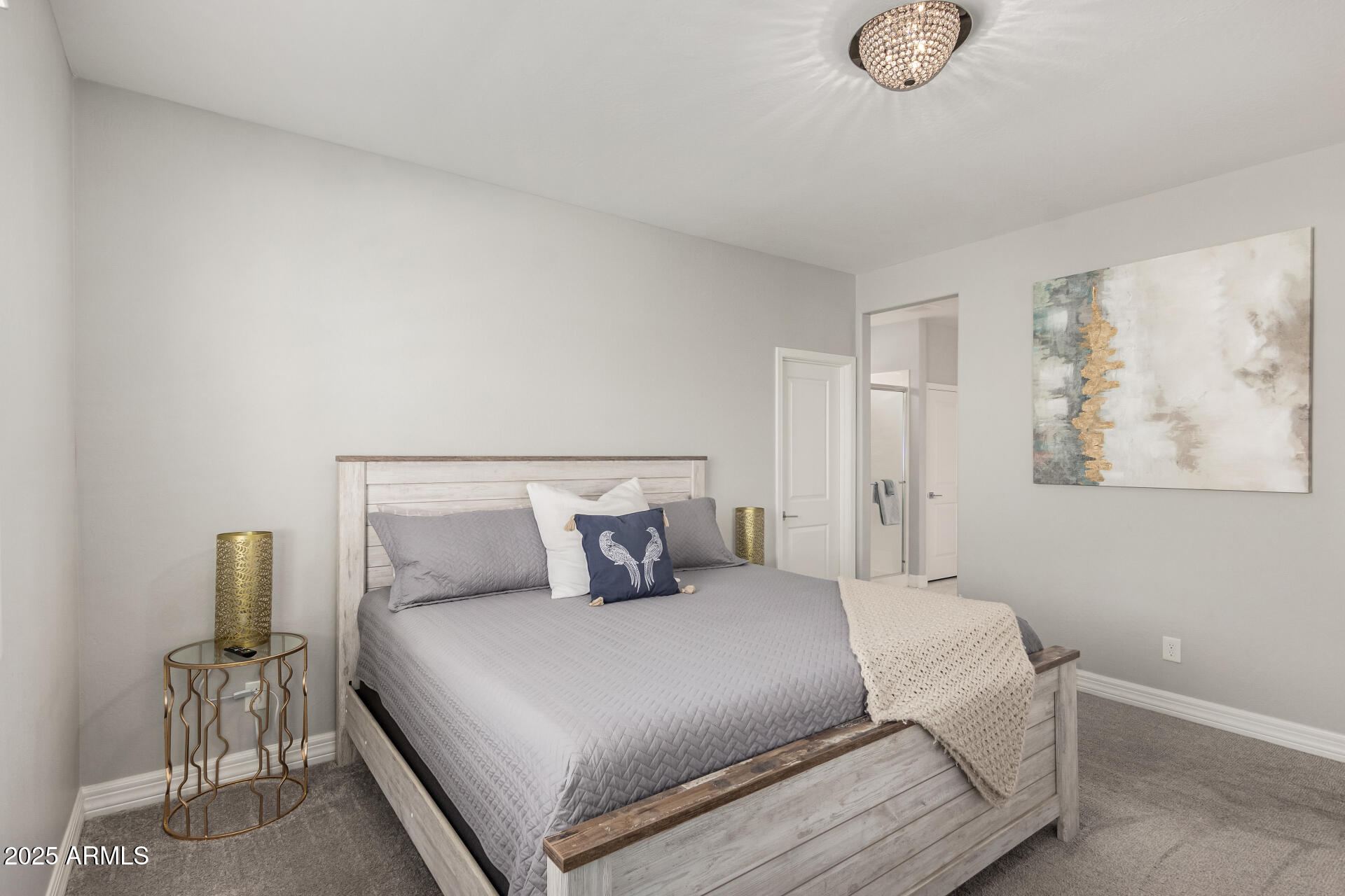 17784 West Sandy Road Goodyear, AZ 85338 - Photo 21 of 38 a bedroom with a bed and painting on the wall
