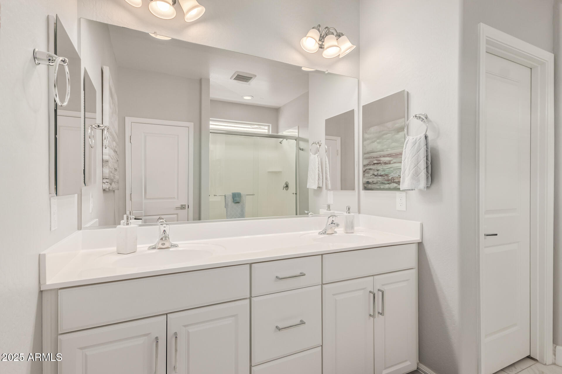 17784 West Sandy Road Goodyear, AZ 85338 - Photo 24 of 38 a bathroom with a sink double vanity and a mirror