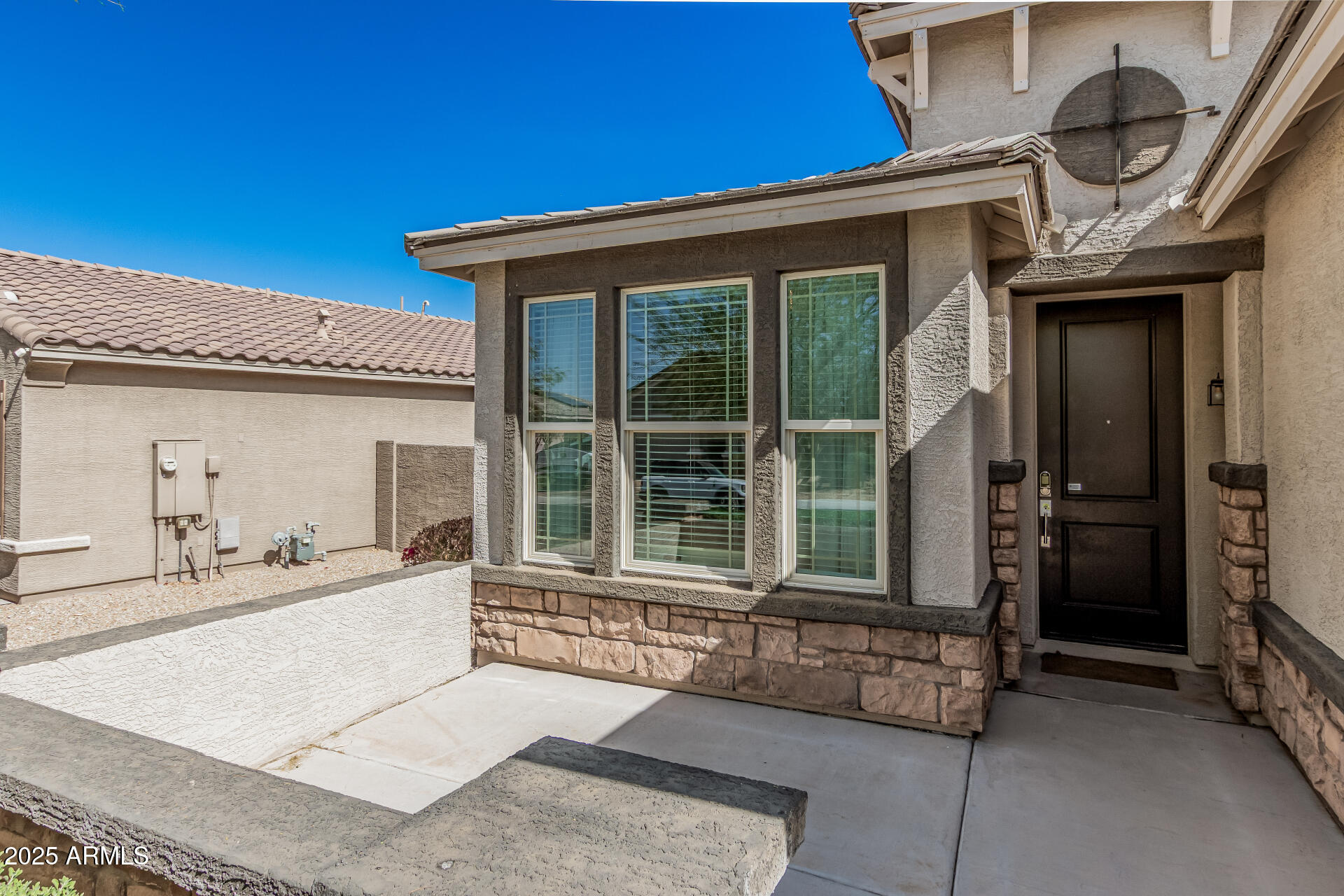 17784 West Sandy Road Goodyear, AZ 85338 - Photo 4 of 38 a front view of a house with large windows