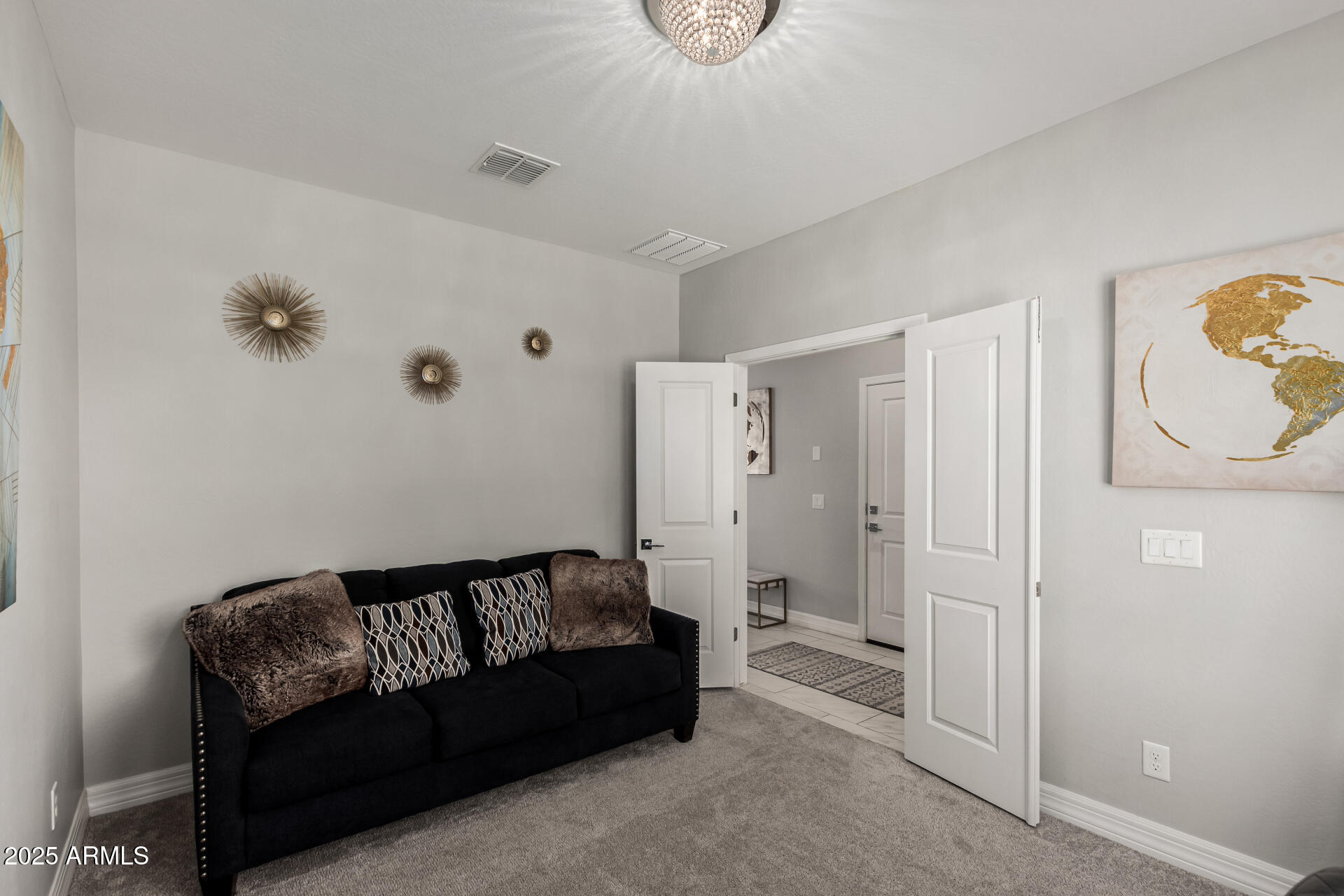 17784 West Sandy Road Goodyear, AZ 85338 - Photo 6 of 38 a spacious bedroom with a couch and a table