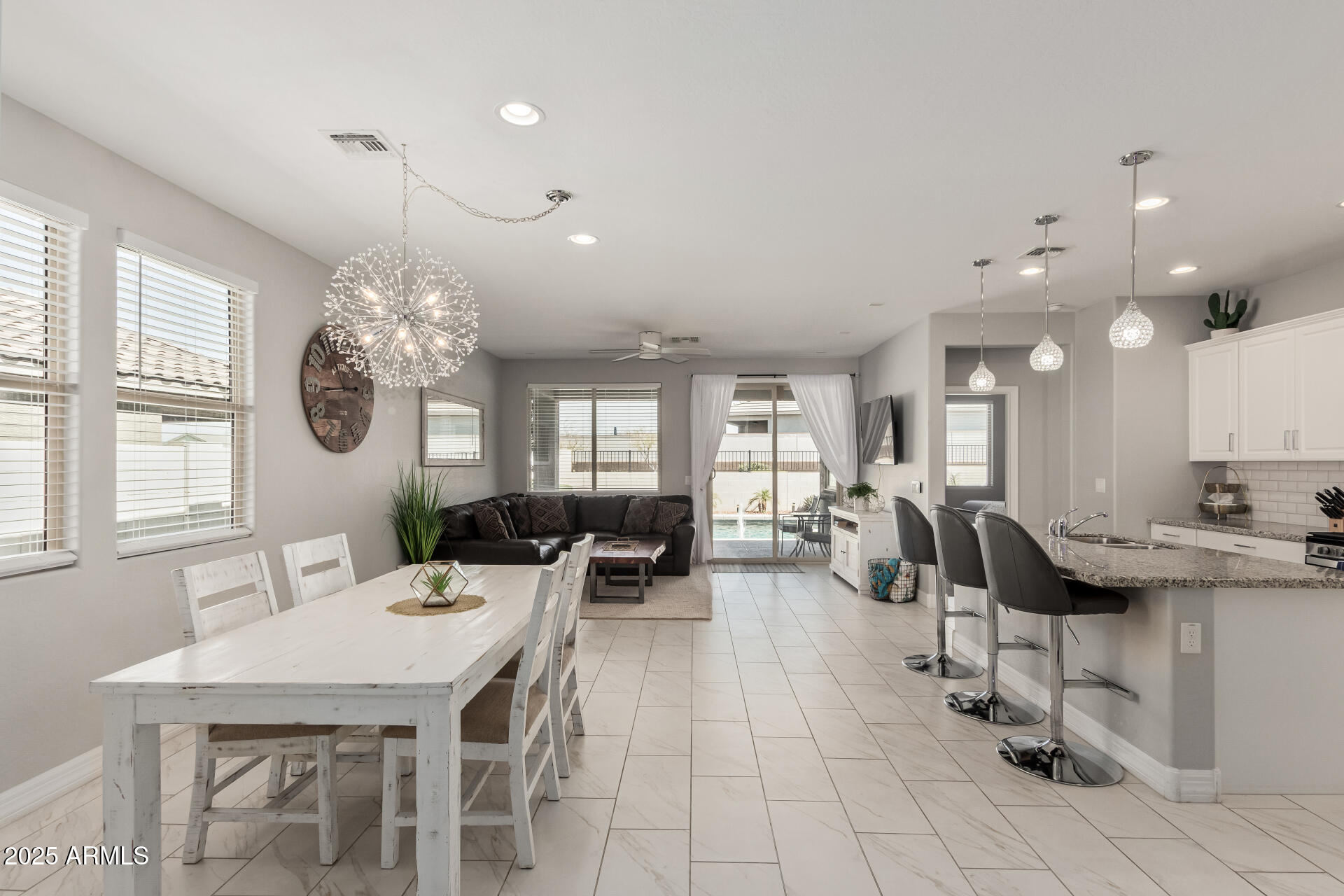 17784 West Sandy Road Goodyear, AZ 85338 - Photo 10 of 38 a large white kitchen with a table and chairs