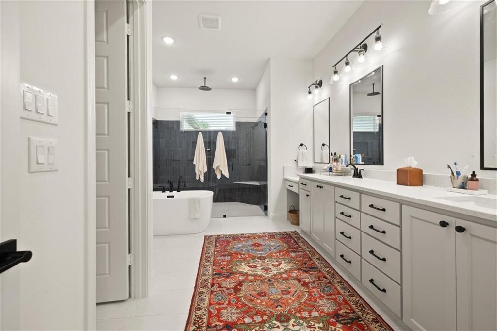 1028 Gatlin Circle Springtown, TX 76082 - Photo 17 of 30 a bathroom with a double vanity sink a mirror and shower