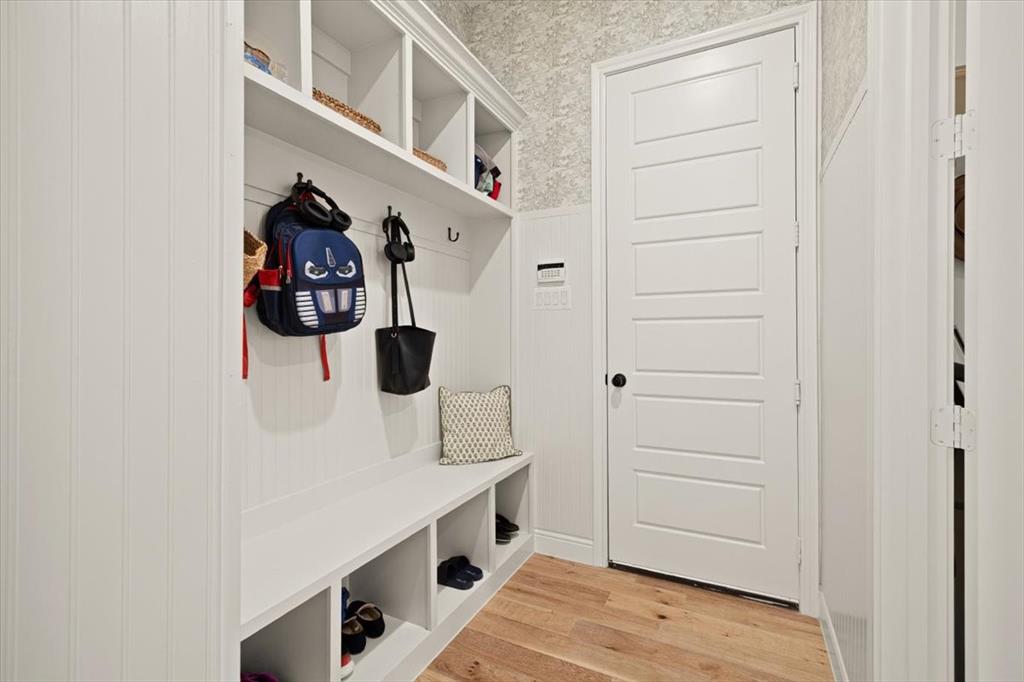 1028 Gatlin Circle Springtown, TX 76082 - Photo 21 of 30 a hallway with white cabinets and wooden floor