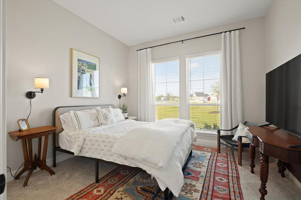 1028 Gatlin Circle Springtown, TX 76082 - Photo 23 of 30 a bedroom with a bed and a table