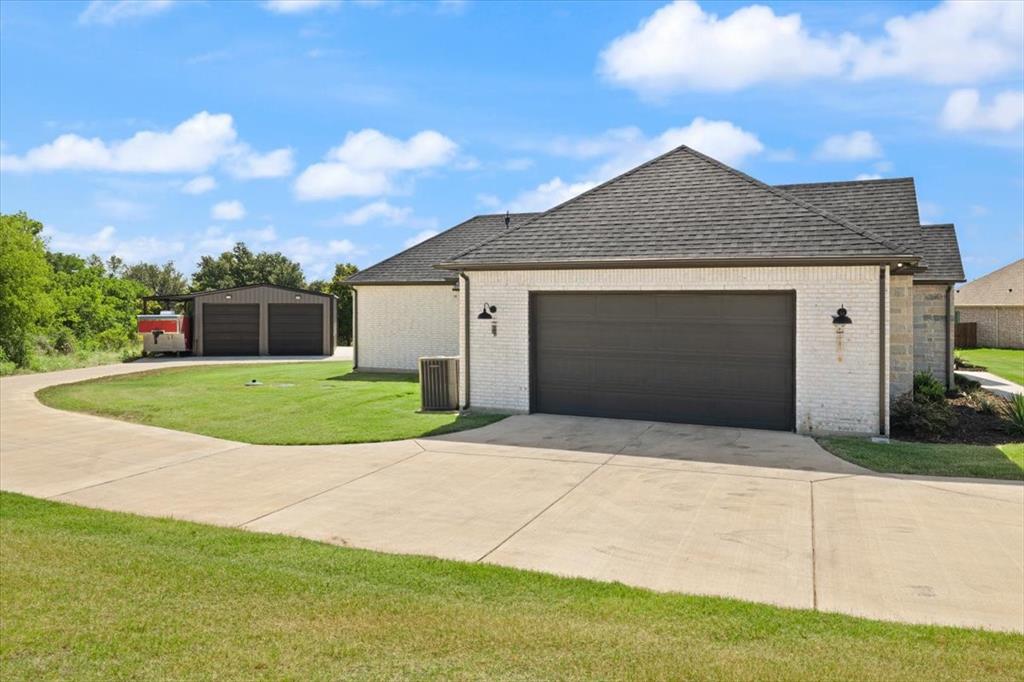 1028 Gatlin Circle Springtown, TX 76082 - Photo 25 of 30 a front view of a house with yard and garage