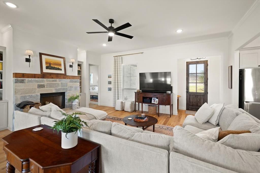 1028 Gatlin Circle Springtown, TX 76082 - Photo 6 of 30 a living room with furniture a fireplace and a flat screen tv