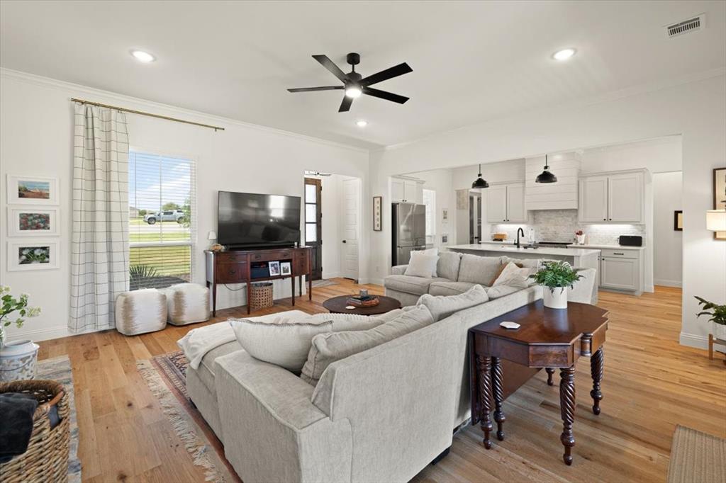 1028 Gatlin Circle Springtown, TX 76082 - Photo 7 of 30 a living room with furniture and a flat screen tv
