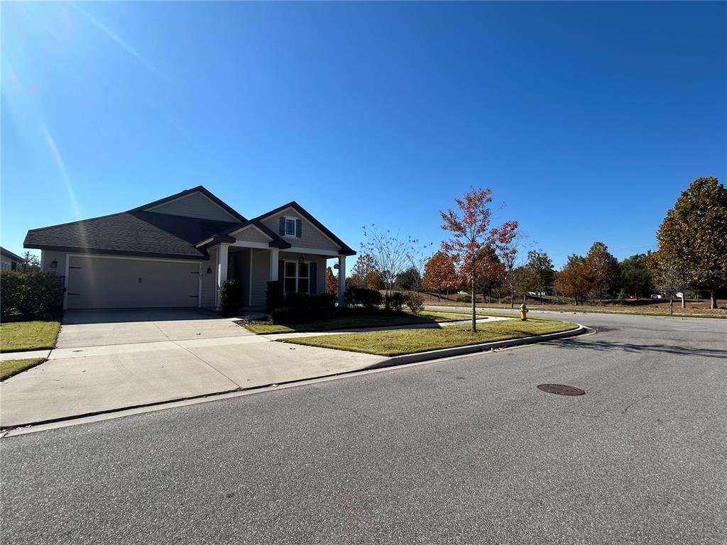 12101 Southwest 29 Place Gainesville, FL 32608 - Photo 24 of 26 a front view of a house with a yard and garage