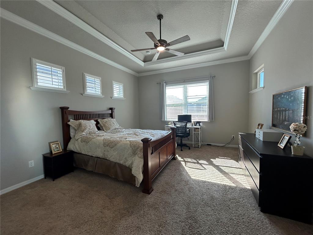 12101 Southwest 29 Place Gainesville, FL 32608 - Photo 7 of 26 a bedroom with bed mirror and window
