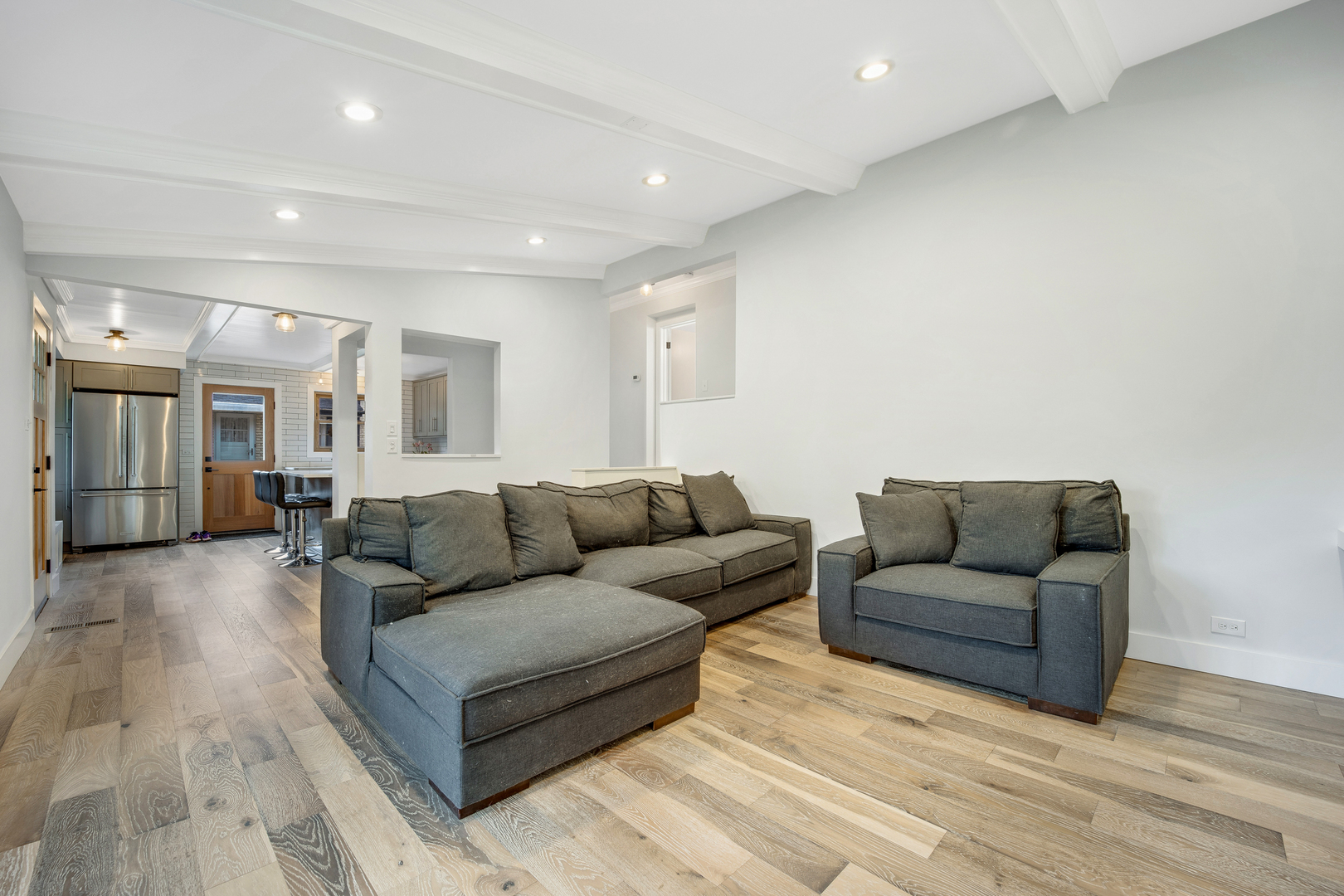 296 Herrick Road Riverside, IL 60546 - Photo 7 of 26 a living room with couches and kitchen view with wooden floor