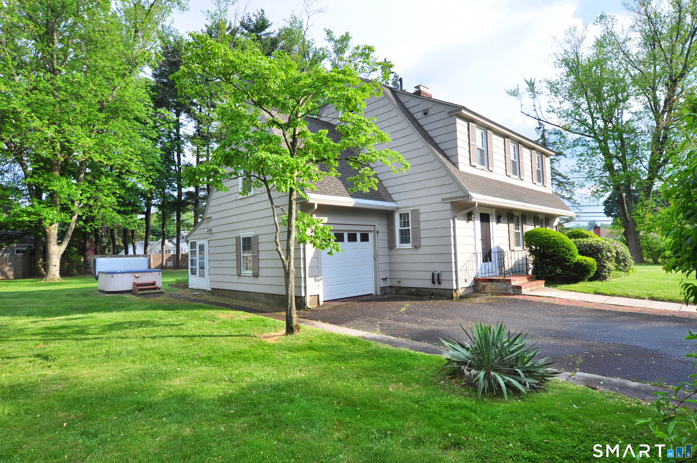 10 Harvey Road Windsor, CT 06095 - Photo 35 of 36 a front view of a house with a yard and table and chairs