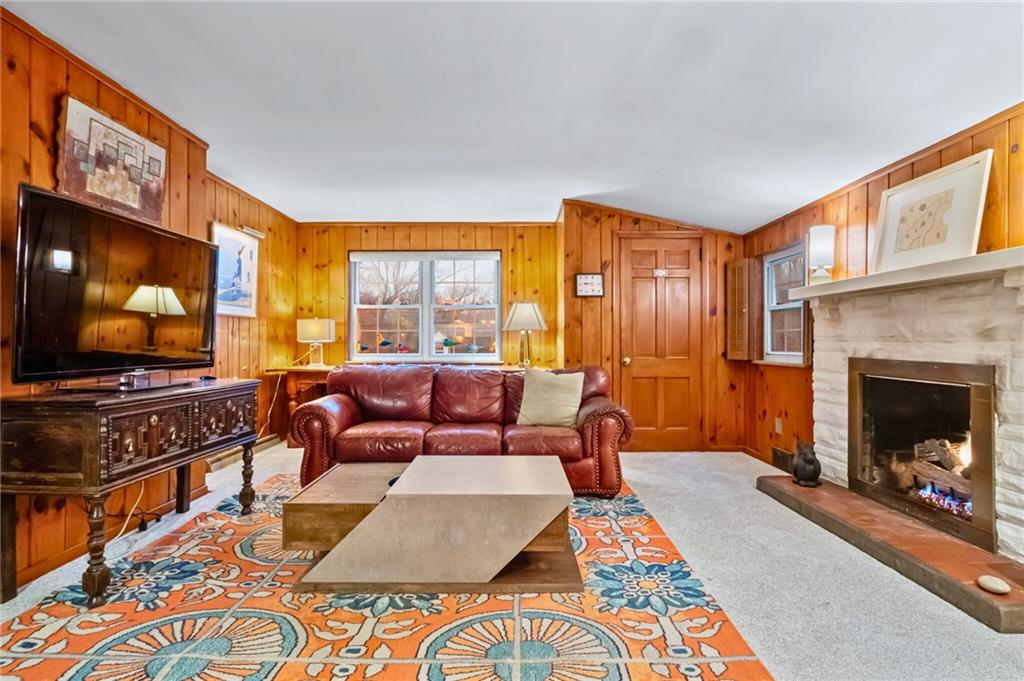 173 Spring Grove Road Pittsburgh, PA 15235 - Photo 4 of 30 a living room with furniture a flat screen tv and a fireplace