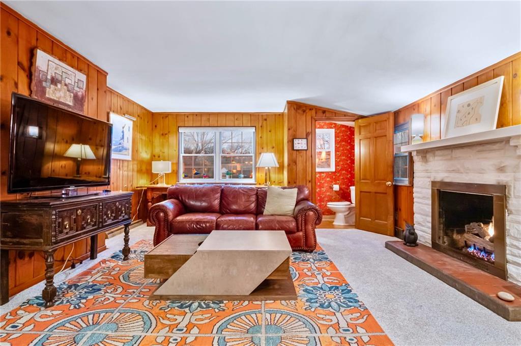 173 Spring Grove Road Pittsburgh, PA 15235 - Photo 5 of 30 a living room with furniture a flat screen tv and a fireplace