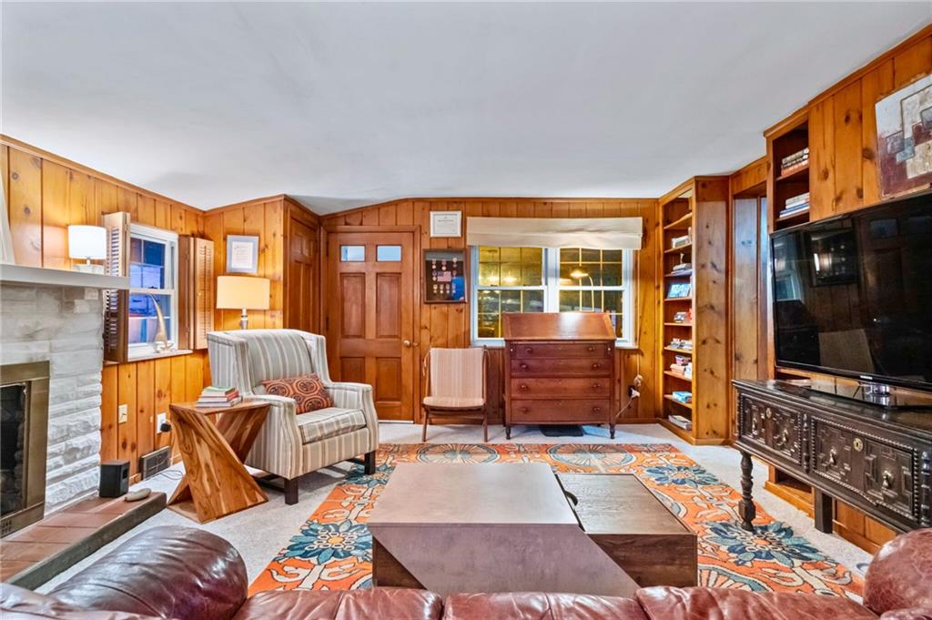 173 Spring Grove Road Pittsburgh, PA 15235 - Photo 7 of 30 a living room with furniture a flat screen tv and a fireplace