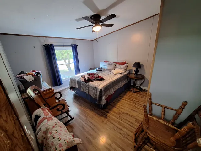 a bedroom with bed and a window