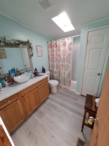 a kitchen with a sink cabinets and wooden floor