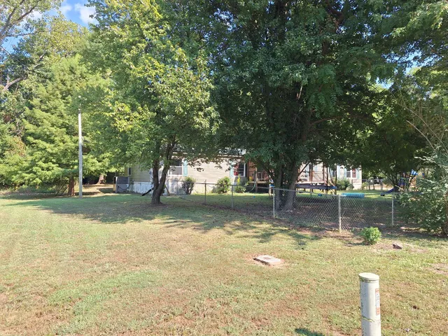 a view of a yard with swimming pool