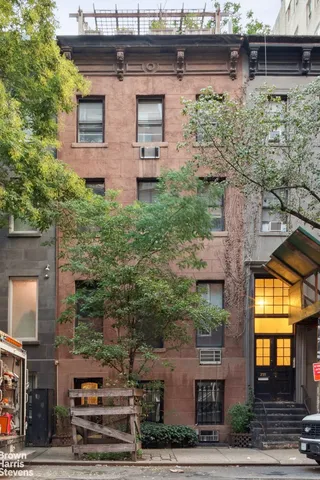 a view of a brick house with large windows